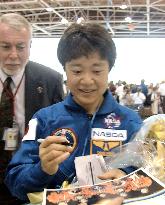 Astronaut Mukai autographs Discovery crew pictures